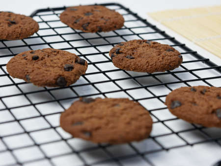 chocolate chip cookies on cooling rack on a white background