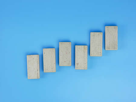 business up and down chart concept, wooden block isolated on blue backgroundの写真素材