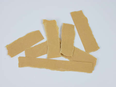 Real brown paper torn or ripped pieces of paper. torn cardboard paper collection. isolated on white.の写真素材