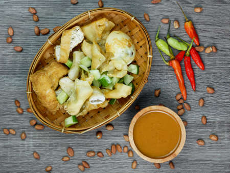 batagor or fried dumplings and peanut sauce with cayenne pepper and scattered peanuts.の写真素材
