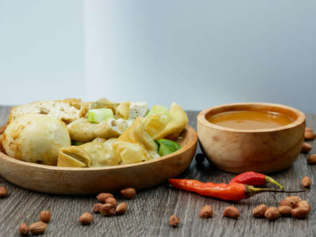 batagor or fried dumplings and peanut sauce with cayenne pepper and scattered peanuts.の写真素材