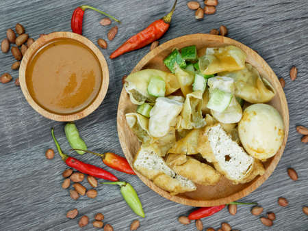 batagor or fried dumplings and peanut sauce with cayenne pepper and scattered peanuts.の写真素材