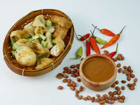 batagor or fried dumplings and peanut sauce with cayenne pepper and scattered peanuts.の写真素材