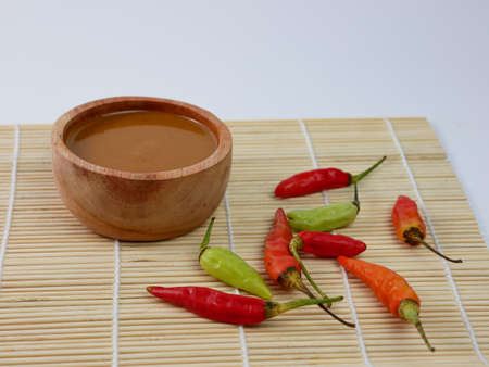 peanut sauce in a small wooden bowl isolated on white background.の写真素材