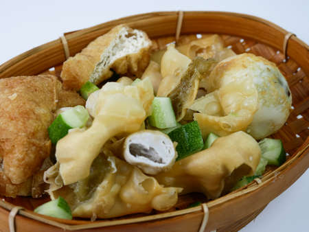 batagor or fried dumplings on a bamboo plateの写真素材