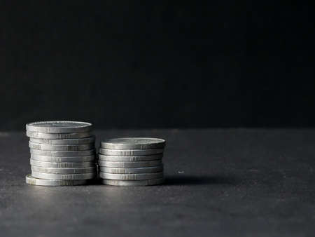 pile of coins on a dark backgroundの写真素材
