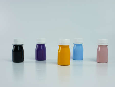 pigment resin paint in the bottle, many colors there are purple, pink, blue, orange, and black. isolated on a white background.の写真素材