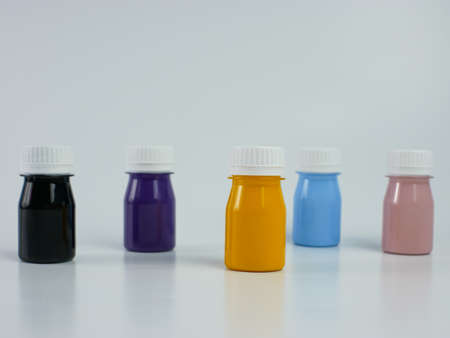 pigment resin paint in the bottle, many colors there are purple, pink, blue, orange, and black. isolated on a white background.の写真素材