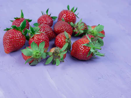 Strawberries on a purple background. healthy and vegetarian fruit concept.の写真素材