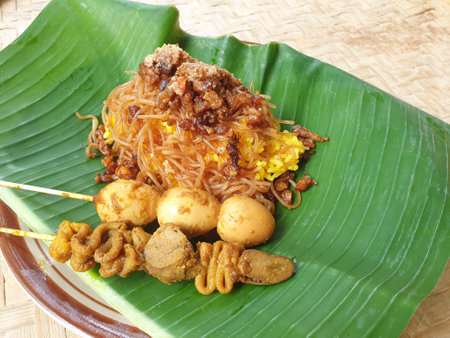 Nasi kuning is a traditional Indonesian dish, served on a banana leaf and plate.の写真素材