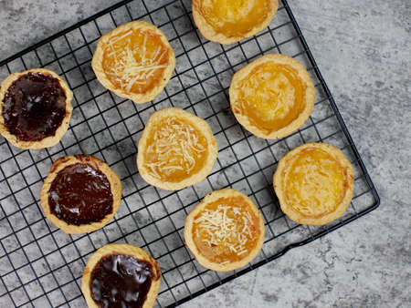 top view of Pineapple, cheese and chocolate flavored pies on a cooling rack. bakery food concept.