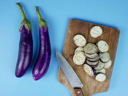 sliced eggplant on a wooden cutting board. healthy vegetable concept for diet.の写真素材