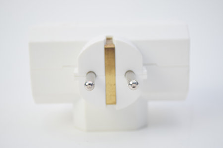 White 3-way electrical power adapter plug for European sockets, isolated on white background