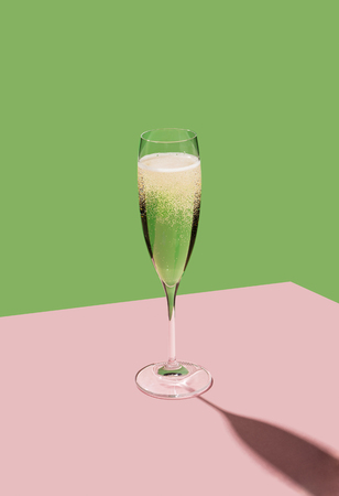 Flutes filled with sparkling prosecco, a white sparkling wine cultivated and produced in Valdobbiadene-Conegliano area. Colorful pop contemporary backgroundの写真素材