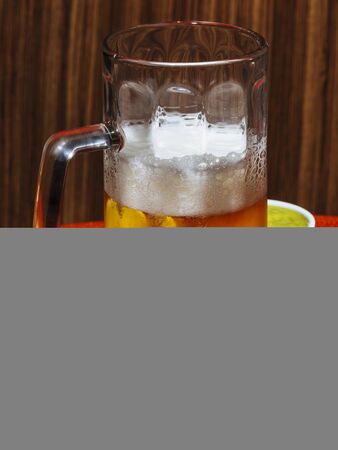 A pint of beer, tortilla chips and guacamole. Pop colorful contemporary styleの写真素材