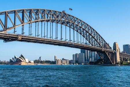 Harbour bridge and the Opera House in a sunny afternoon with a blue sky backgroundのeditorial素材
