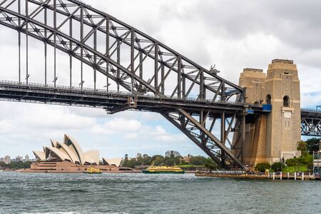 Harbour bridge and the Opera House in the late afternoon with a partially cloudy sky backgroundのeditorial素材