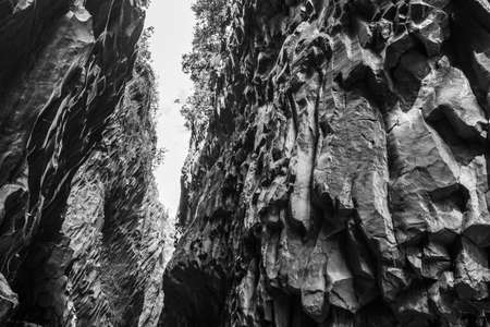 View of basalt rocks, waterfalls and pristine water of Alcantara gorges in Sicily, Italy