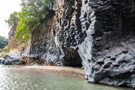 View of basalt rocks, waterfalls and pristine water of Alcantara gorges in Sicily, Italyの写真素材