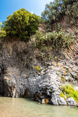 View of basalt rocks, waterfalls and pristine water of Alcantara gorges in Sicily, Italyの写真素材