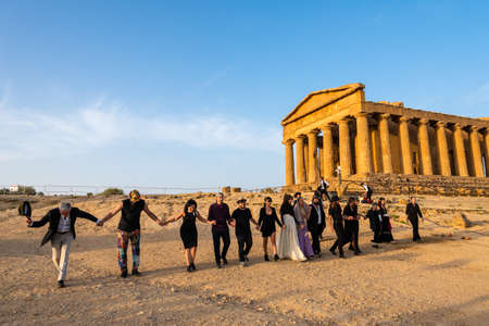 Artists perform after dusk at Concordia Temple in a summer sunny morningのeditorial素材