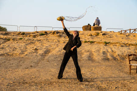 Artists perform after dusk at Concordia Temple in a summer sunny morningのeditorial素材