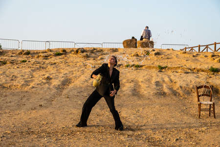 Artists perform after dusk at Concordia Temple in a summer sunny morningのeditorial素材