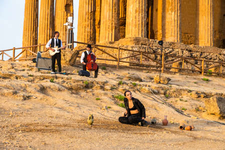Artists perform after dusk at Concordia Temple in a summer sunny morningのeditorial素材