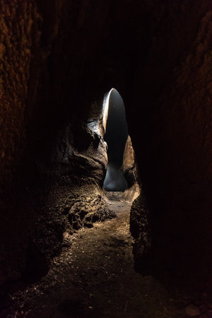 View from inside of Serracozzo volcanic cave on mount Etna, Italy
