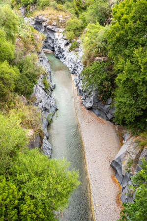 Basalt rocks and pristine water of Alcantara gorges in Sicily, Italyの写真素材