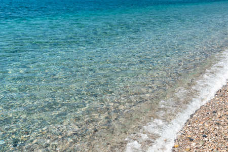 Pristine and calm Mediterranean sea water next to the shoreline, Sicilyの写真素材