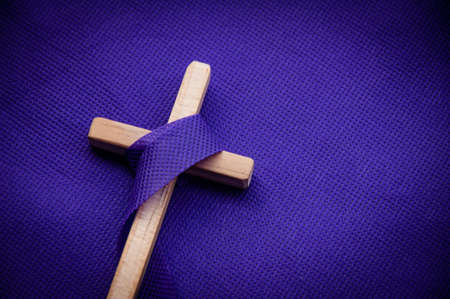 Religious cross on purple background. Good Friday, Lent season and Holy week conceptの写真素材