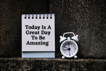 Motivational and inspirational quote on notepad - Today is a great day to be amazing. With rock and alarm clock background. Motivational conceptの写真素材