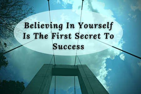 Motivational quote - Believing in yourself is the first secret to success. Blue sky and bridge background. Motivational conceptの写真素材