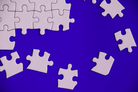 Top view of missing jigsaw puzzle on blue cover background. Copy space conceptの写真素材