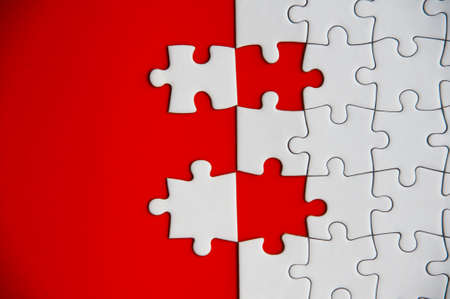 Top view of missing jigsaw puzzle on red cover background. Copy space conceptの写真素材