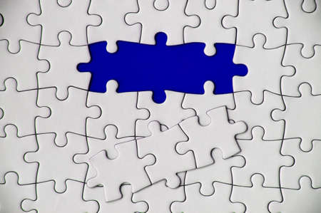 Top view of missing jigsaw puzzle on blue cover background. Copy spaceの写真素材