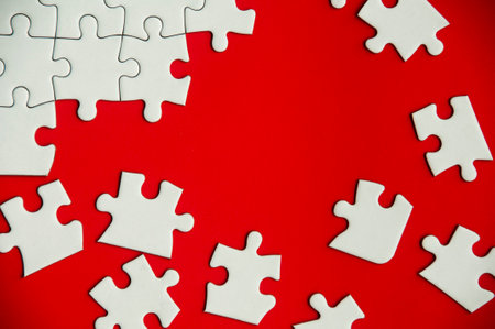 Top view of missing jigsaw puzzle on red cover background. Copy space conceptの写真素材