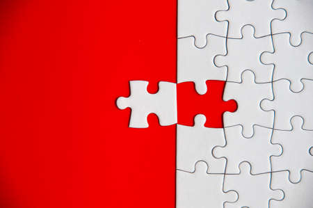 Top view of missing jigsaw puzzle on red cover background. Copy space conceptの写真素材