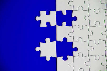 Top view of separated jigsaw puzzle on blue cover background. Copy space conceptの写真素材