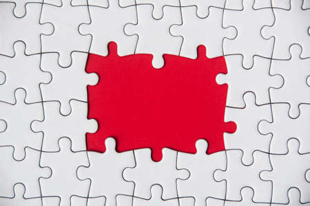 Top view of missing jigsaw puzzle on red cover background. Copy space conceptの写真素材