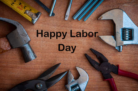 Text on wooden desk - Happy Labor Day with working tools background. Labor day concept.の写真素材