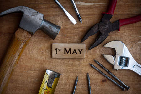 Text on wooden block - 1st May with working tools background. Labor day concept.の写真素材