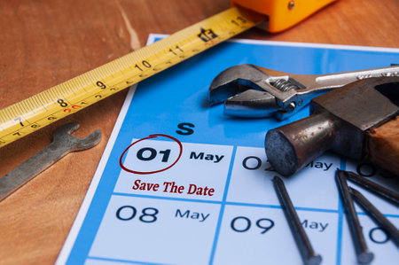 Side view of Save the date text on calendar with working tools background. Copy space and labor day concept.の写真素材