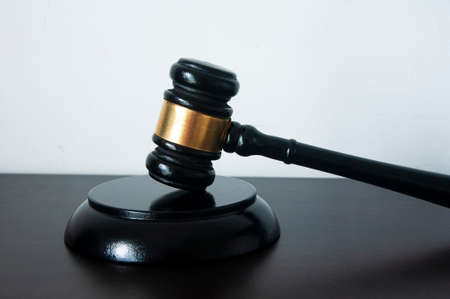 Lawyer gavel on wooden table with white background. Law conceptの写真素材