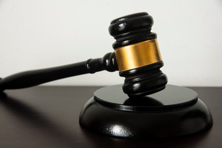 Straight view of lawyer gavel on wooden table with white background. Law conceptの写真素材