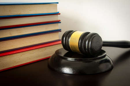 Lawyer gavel on wooden table with white and books background. Law conceptの写真素材