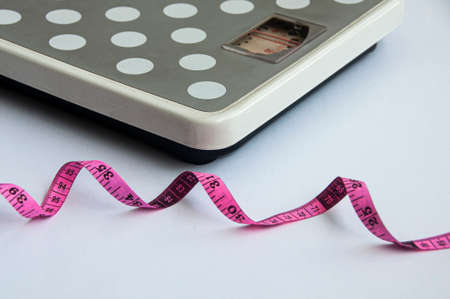 Measuring tape and weight scale on white background. Weight loss and fitness conceptの写真素材