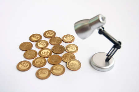 Lamp with gold coins on white background. Business and copy space conceptの写真素材