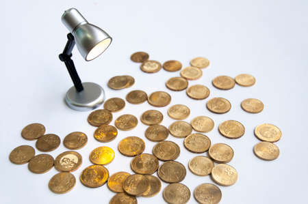 Lamp with gold coins on white background. Business and copy space conceptの写真素材